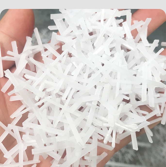 White cross-shaped tile spacers